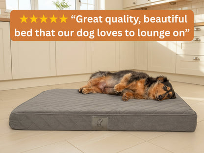 Dachshund lying on a grey quilted dog mattress bed in a kitchen with a five-star customer review overlay