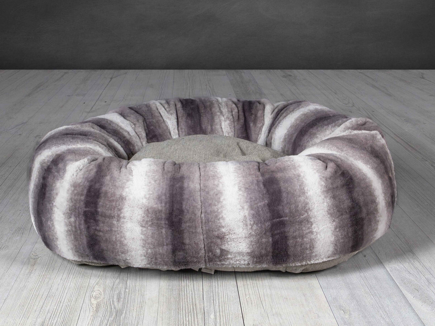 Grey faux fur donut dog bed with deep cushion and raised edge
