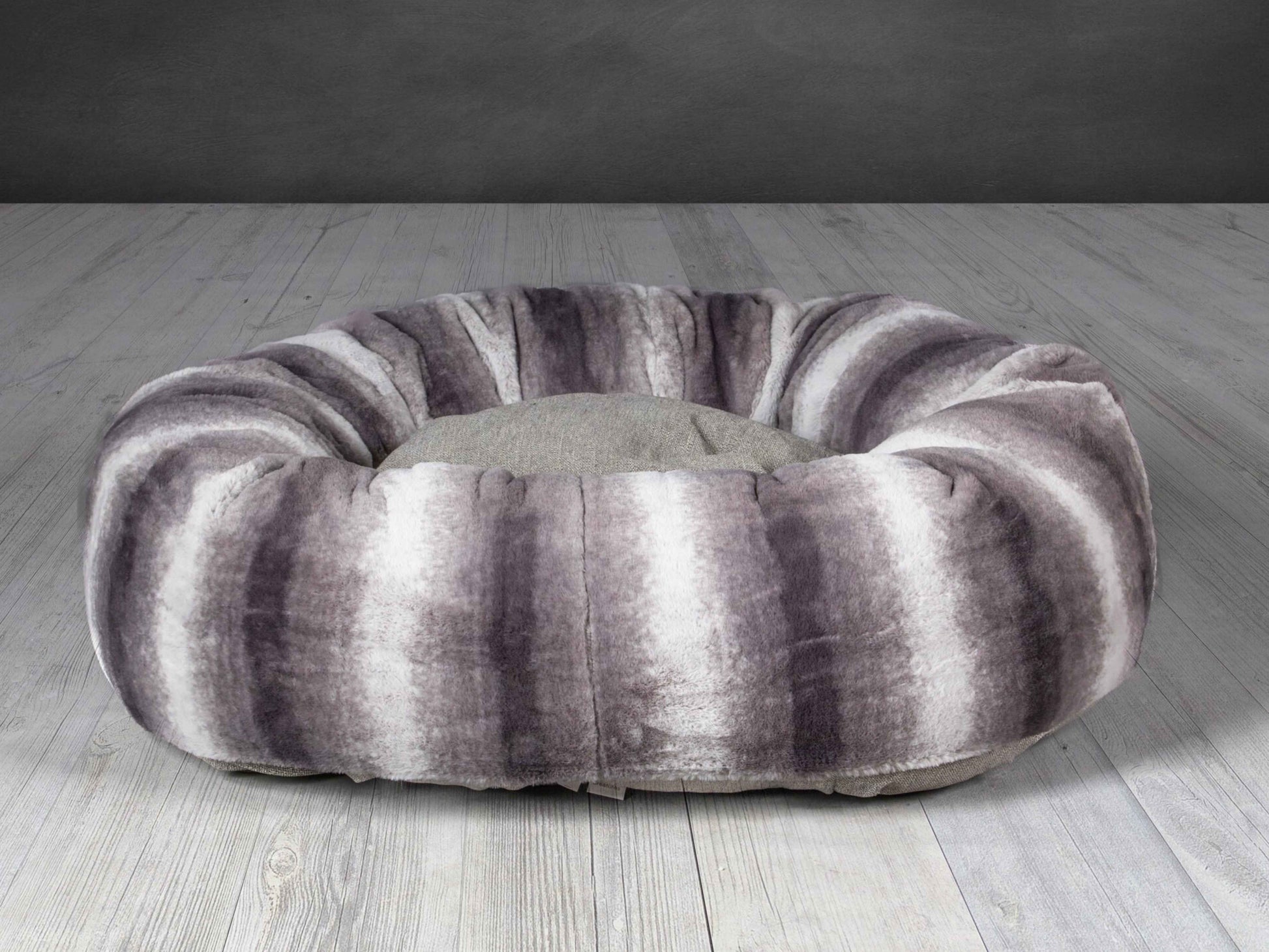 Grey faux fur donut dog bed with deep cushion and raised edge