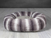 Grey faux fur donut dog bed with deep cushion and raised edge