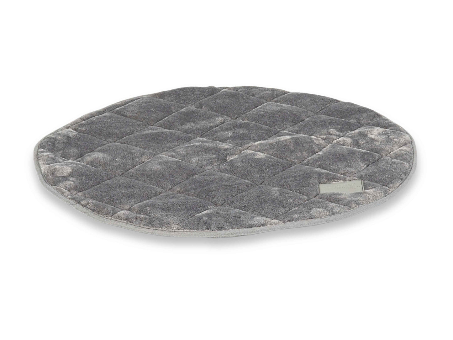 Angled view of grey quilted round dog mat with soft plush finish and piped edges
