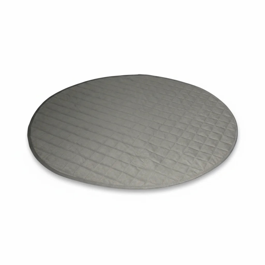 Round gray quilted dog mat on a white background
