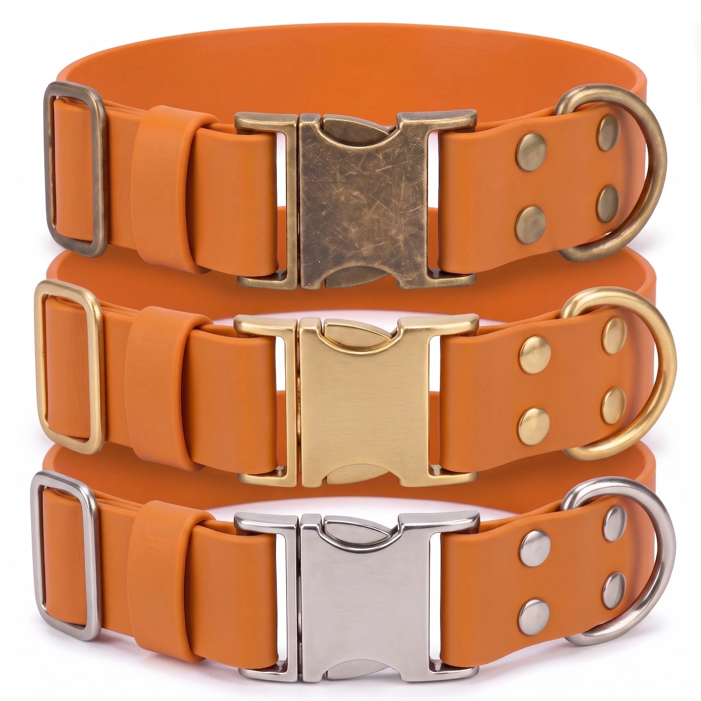 Three orange biothane dog collars stacked vertically, each with a different metal buckle and ring finish: antique bronze, gold, and silver.