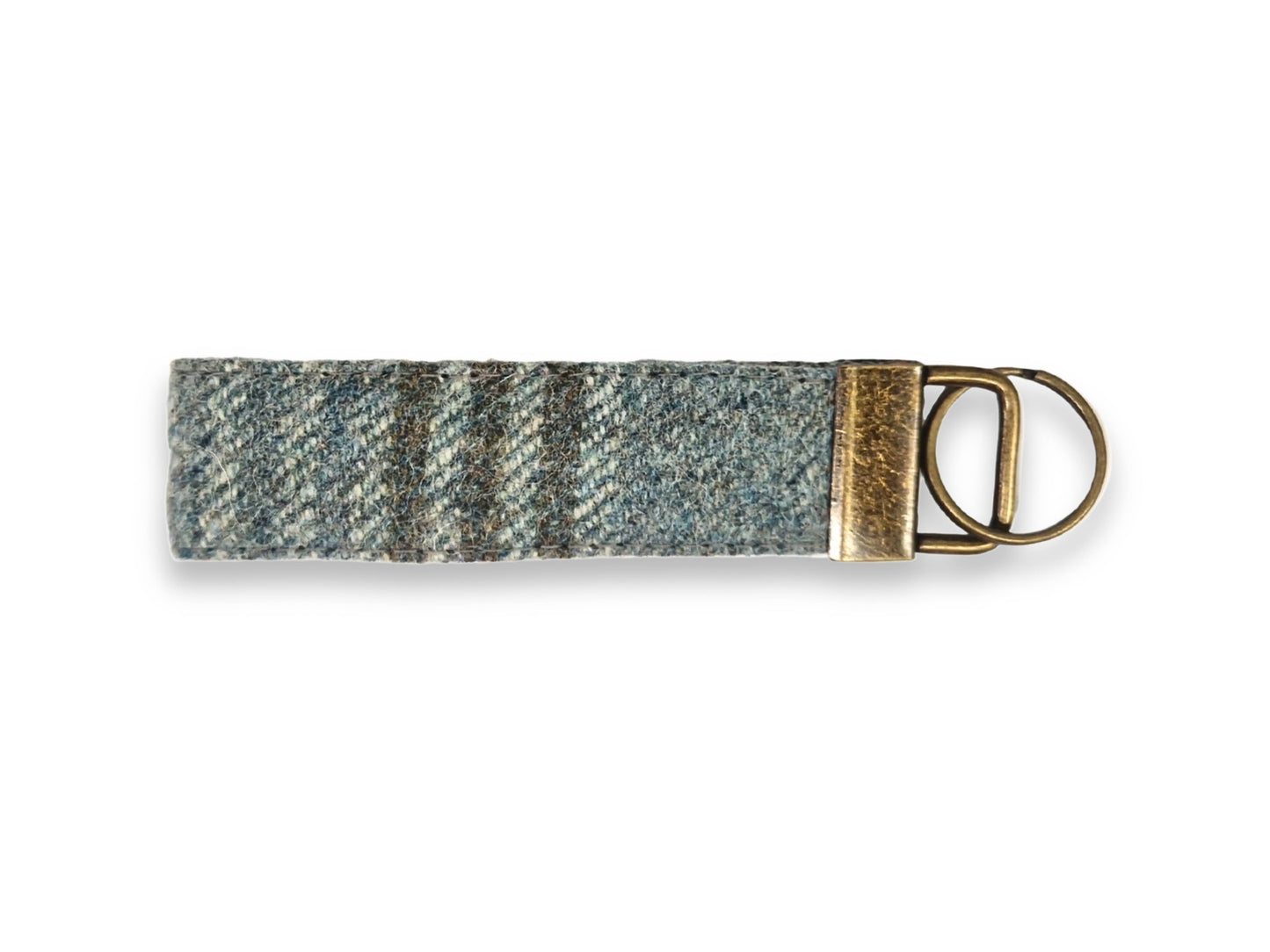 Woven tweed keyring with a metal ring on a white background