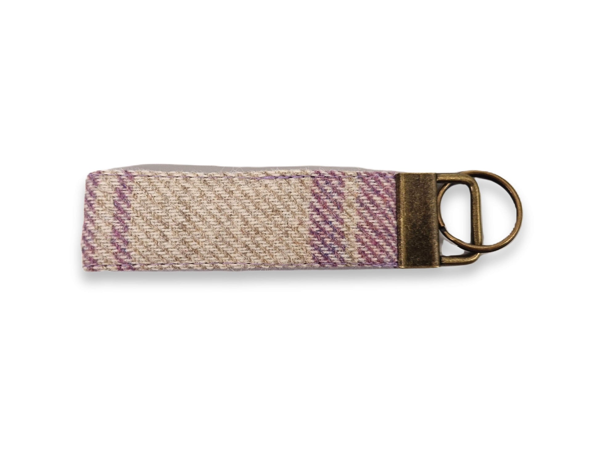 Woven abraham moon tweed keyring with a metal ring on a white background