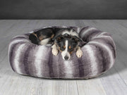 Border Collie resting in soft grey donut dog bed for medium to large dogs