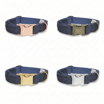 Four dark blue dog collars with metal buckles on a white background