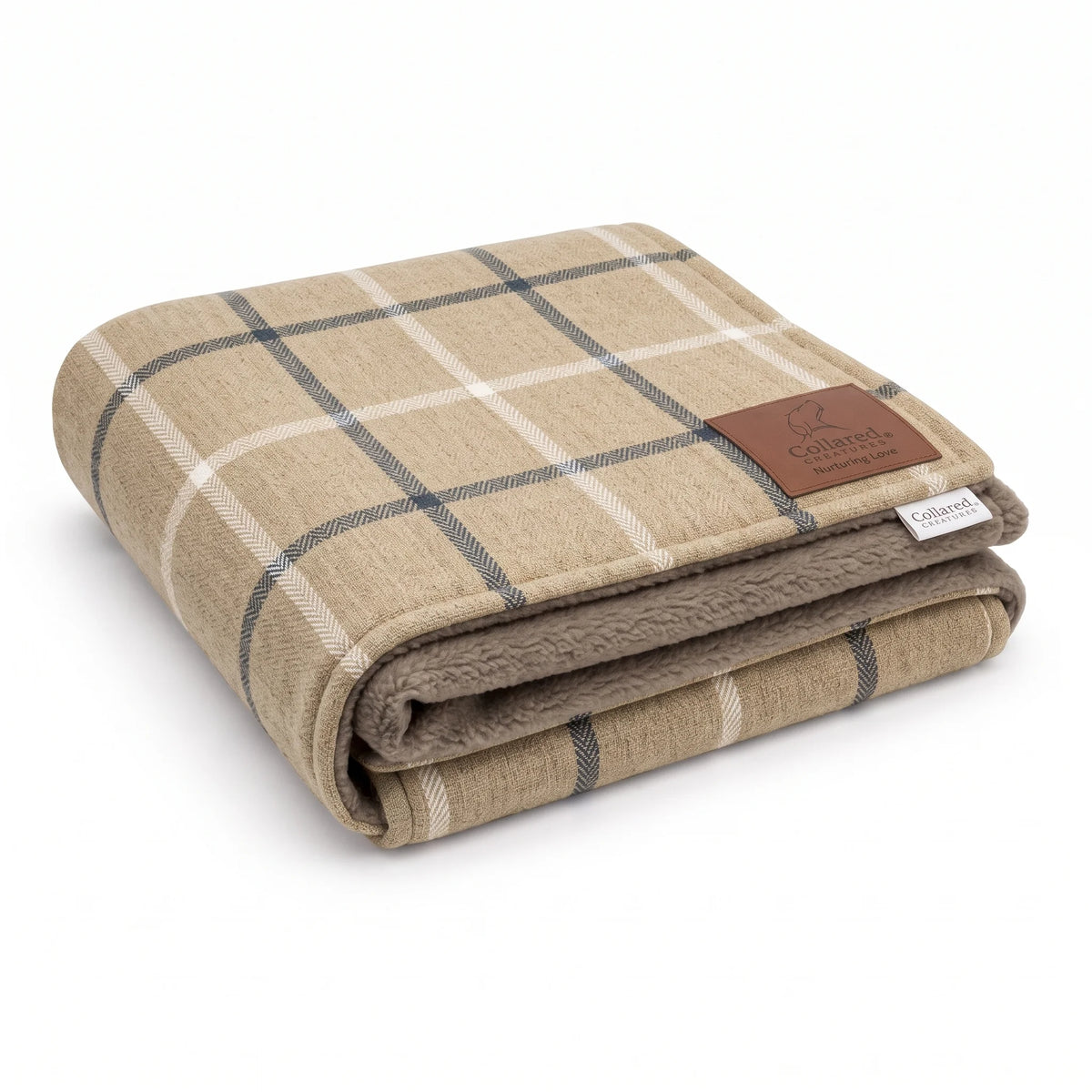 Folded Mull Latte dog blanket in latte beige with navy and cream windowpane check, taupe fleece lining and leather effect brand patch