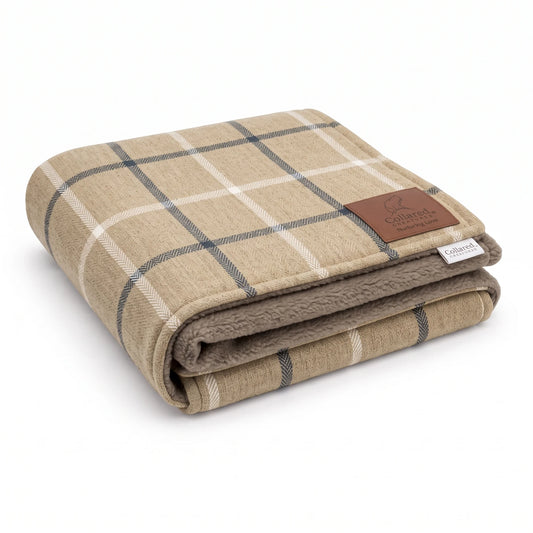 Folded Mull Latte dog blanket in latte beige with navy and cream windowpane check, taupe fleece lining and leather effect brand patch