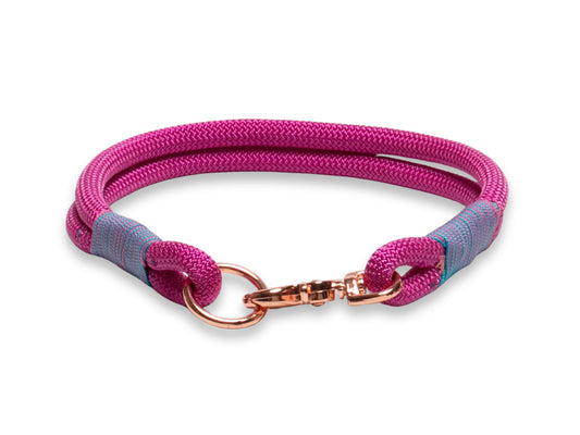 Pink and blue braided dog collar with rose gold clasp on a white background