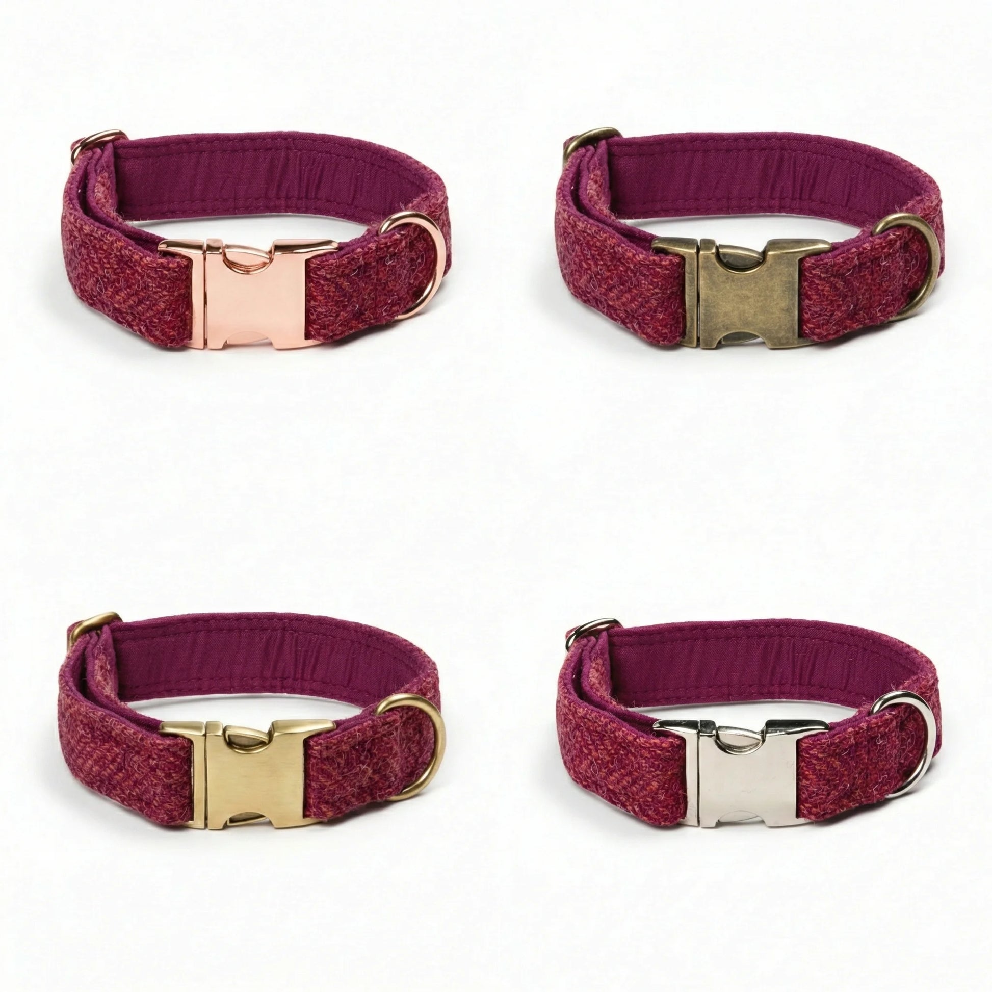 Four burgundy dog collars with gold and silver buckles on a white background