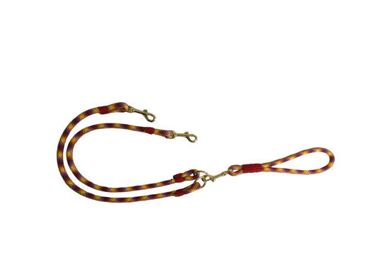 Red and yellow patterned dog leash on a white background
