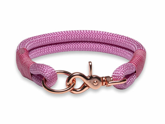 A pink handmade rope dog collar with whipping, displayed on a white background.