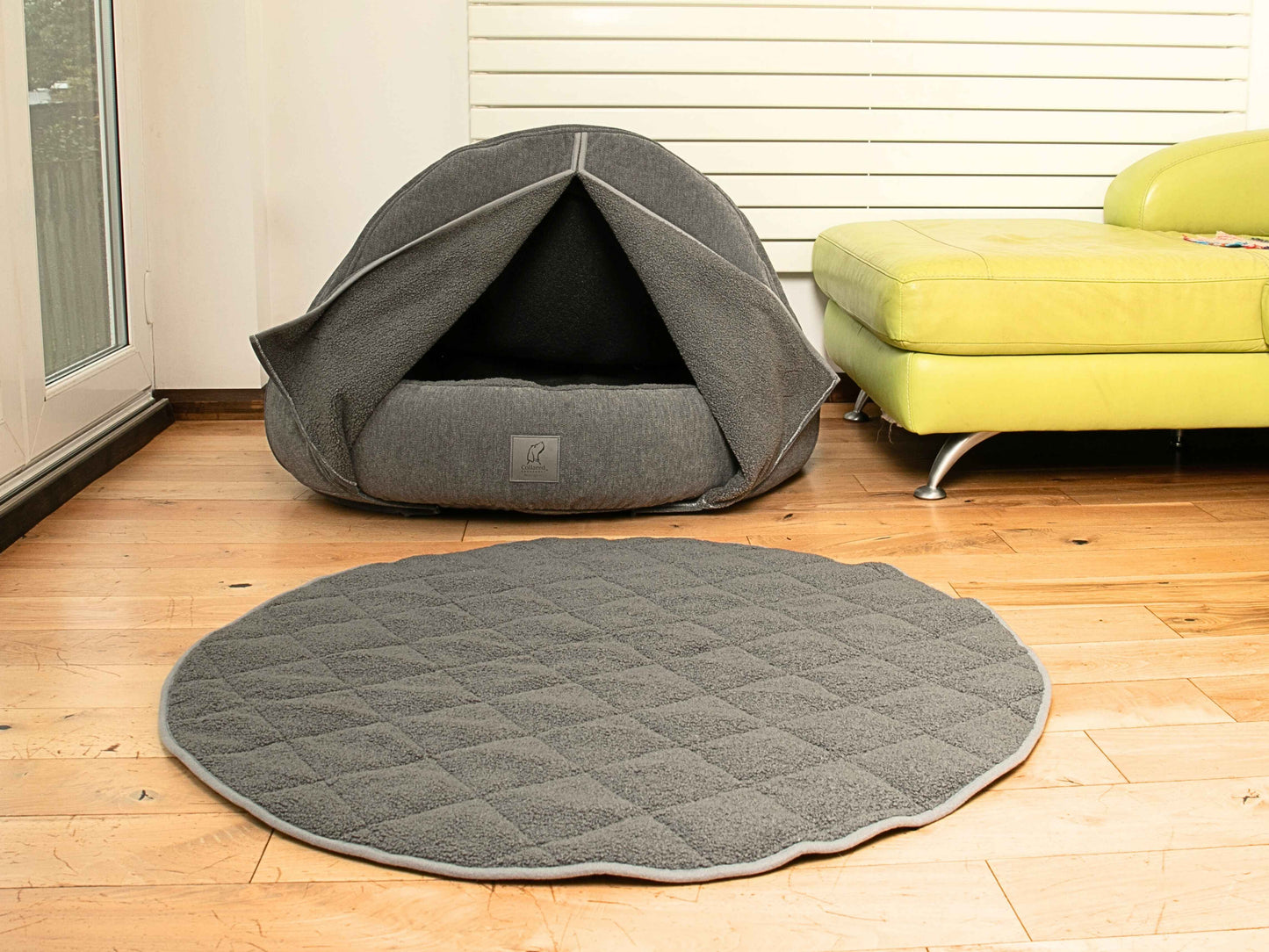 round teddy fur dog blanket in front of covered dog bed with curtains