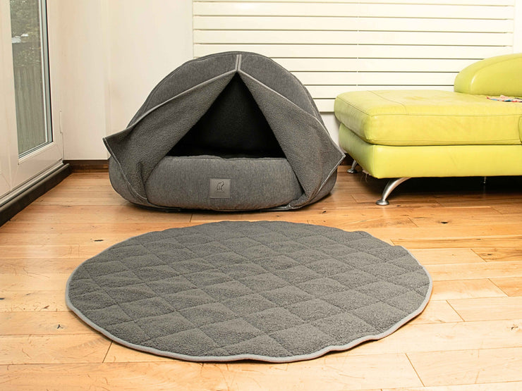 round teddy fur dog blanket in front of covered dog bed with curtains