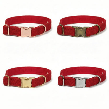 Four red dog collars with different metal buckles on a white background