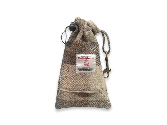 Herringbone drawstring dog treat pouch with a label on a white background