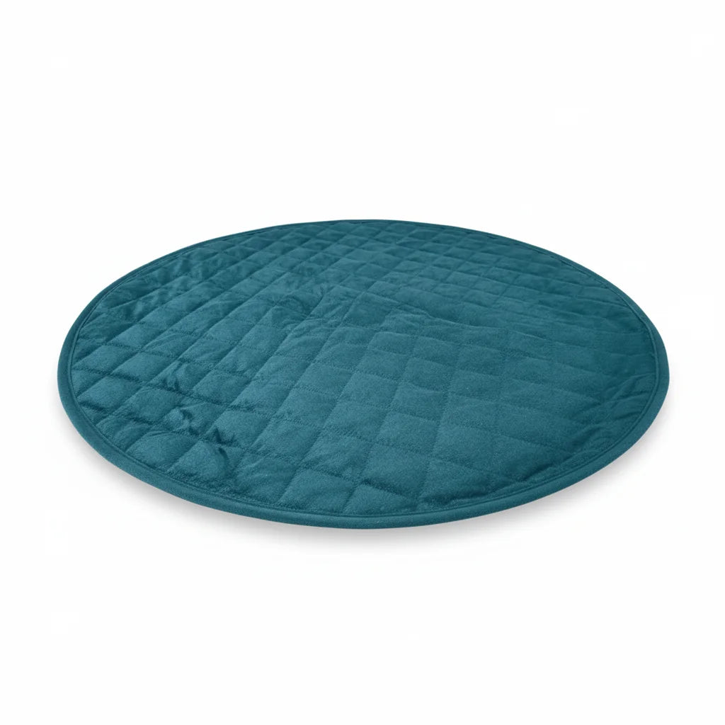 Teal round quilted mat on a white background