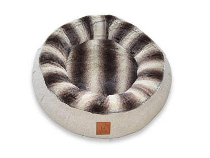 Top view of beige donut dog bed with deep brown striped faux fur inner cushion by Collared Creatures, displayed on a white background.