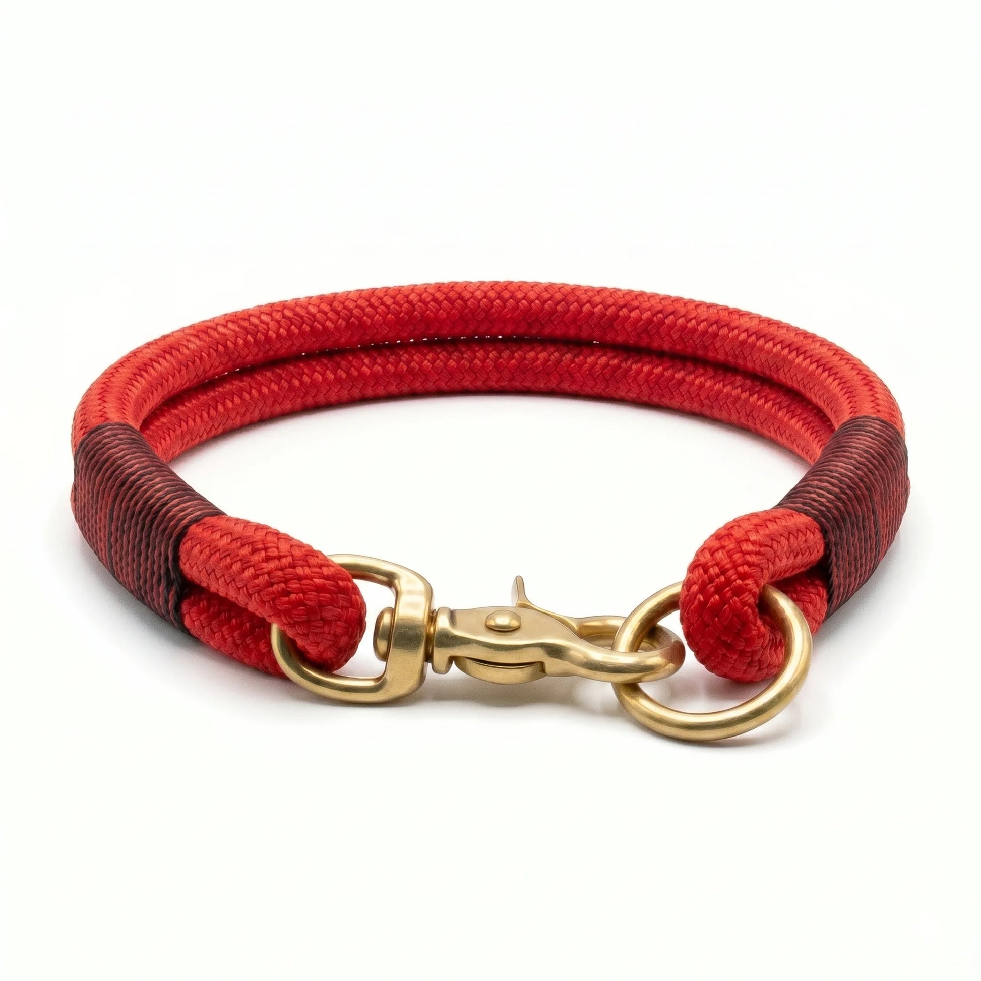 Red rope collar with black and red whipping and gold clasp on a white background by collared creatures