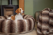 Tan and white beagle laying in a collared creatures luxury brown faux fur donut dog bed with matching luxury brown faux fur dog blanket - sofa throw at the side